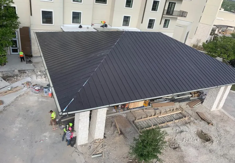 Metal roofing installation team working on a commercial building in Live Oak